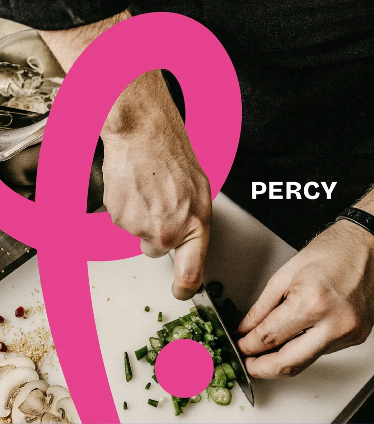 A chef slicing fresh chillies on a prep bench